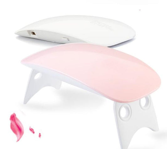 Portable USB LED nail light therapy machine in pink and white, compact design for quick drying.