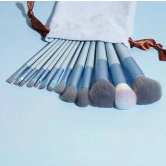 13Pcs blue makeup brush set with white bag, including various types of brushes.