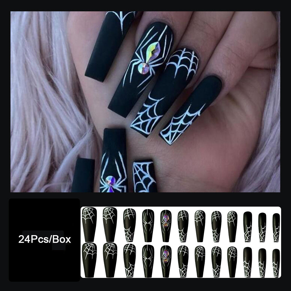 Dark Spider Halloween nail set featuring black nails with white web designs and gem accents, 24 pieces per box.