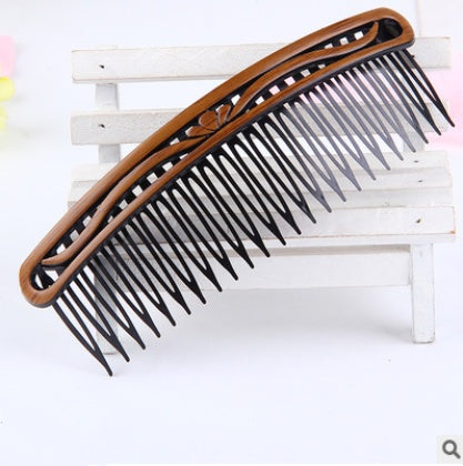 Fashion retro hair comb with black plastic teeth and brown design.