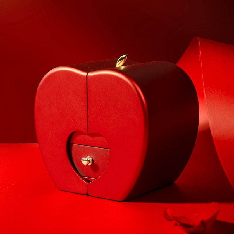 Red apple-shaped fashion jewelry box with a heart design, ideal for gifting on Valentine's Day, Mother's Day, and Christmas.
