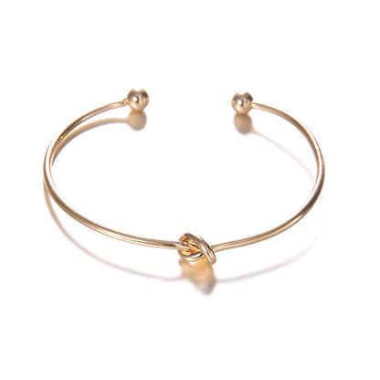 Women's vintage cuff arrow knotted bracelet in alloy material.