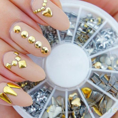 Gold and silver DIY decorative nail art stickers on acrylic nails.