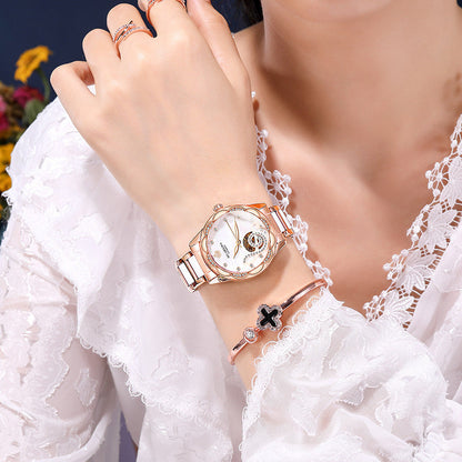 Women's luxury designer mechanical watch with ceramic, stainless steel strap, and luminous features.