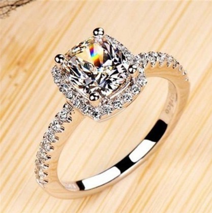 Elegant women's wedding engagement ring in white gold color with diamond treatment, silver tone.