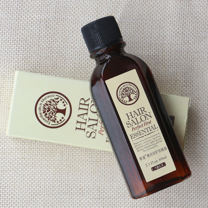 Hair Salon Protect Hair Essential Oil bottle on textured background, moisturizing and nourishing formula for smooth, glossy hair.