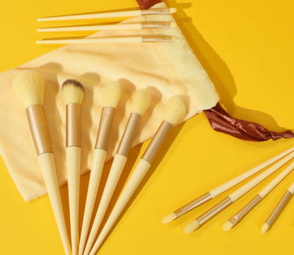 13Pcs Makeup Brush Set with cosmetic bag on a yellow background.