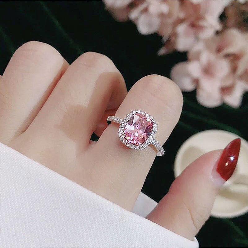 Elegant women's bridal engagement ring with pink gemstone in white gold color.