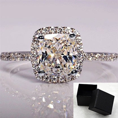 White gold color engagement ring for women with artificial gemstone and diamond treatment.