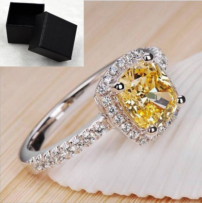 Elegant white gold color engagement ring with yellow gemstone for women.