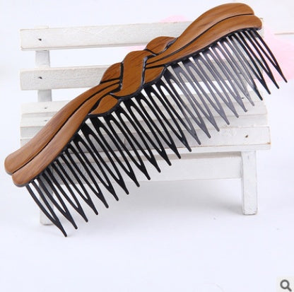 Fashion retro hair comb with wavy design, made of plastic resin.