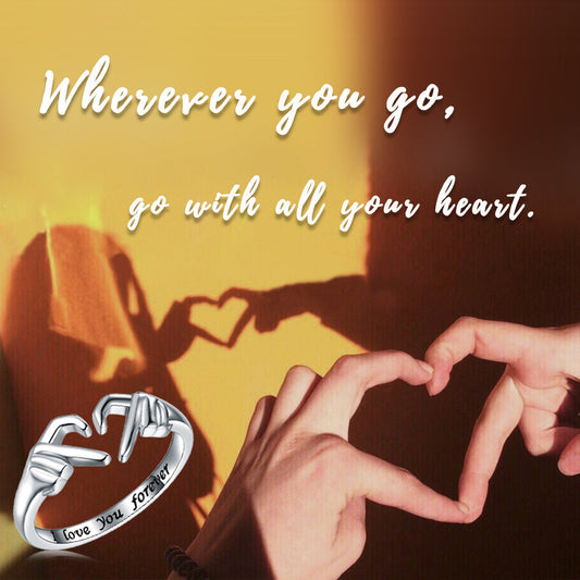 Romantic heart hand hug fashion ring with engraved "I love you forever" on background.