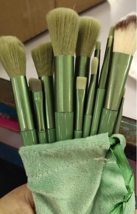 13Pcs green makeup brush set with cloth pouch, including foundation, powder, and eyeshadow brushes.
