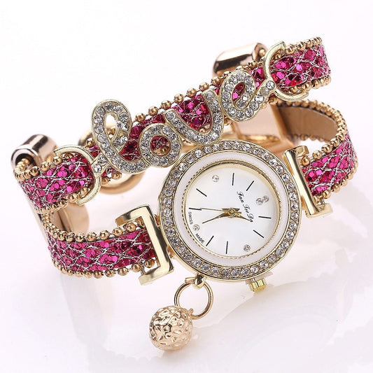 FanTeeDa Brand women's rhinestone bracelet watch with pink strap and "love" design.