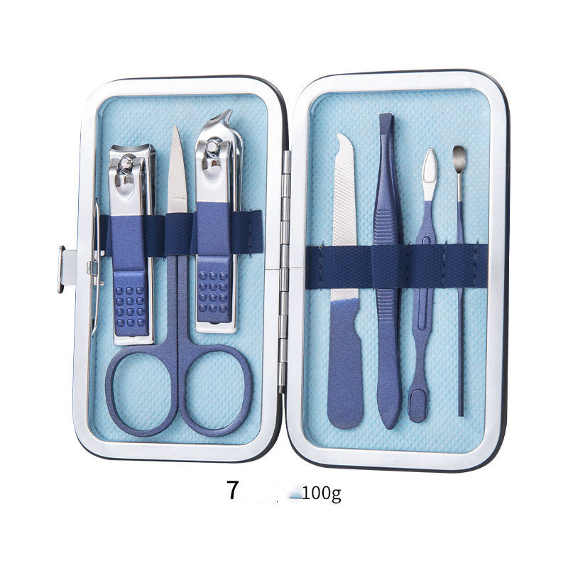 Professional scissors nail clippers set with ear spoon, dead skin pliers, and pedicure tools in a compact blue case.