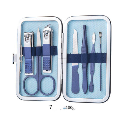 Professional scissors nail clippers set with ear spoon, dead skin pliers, and pedicure tools in a compact blue case.
