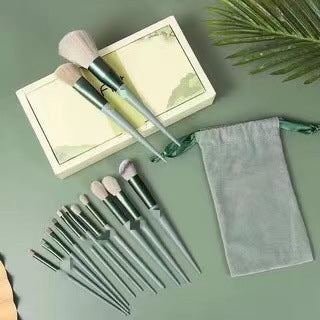 13Pcs makeup brush set with green handles, includes box and pouch.